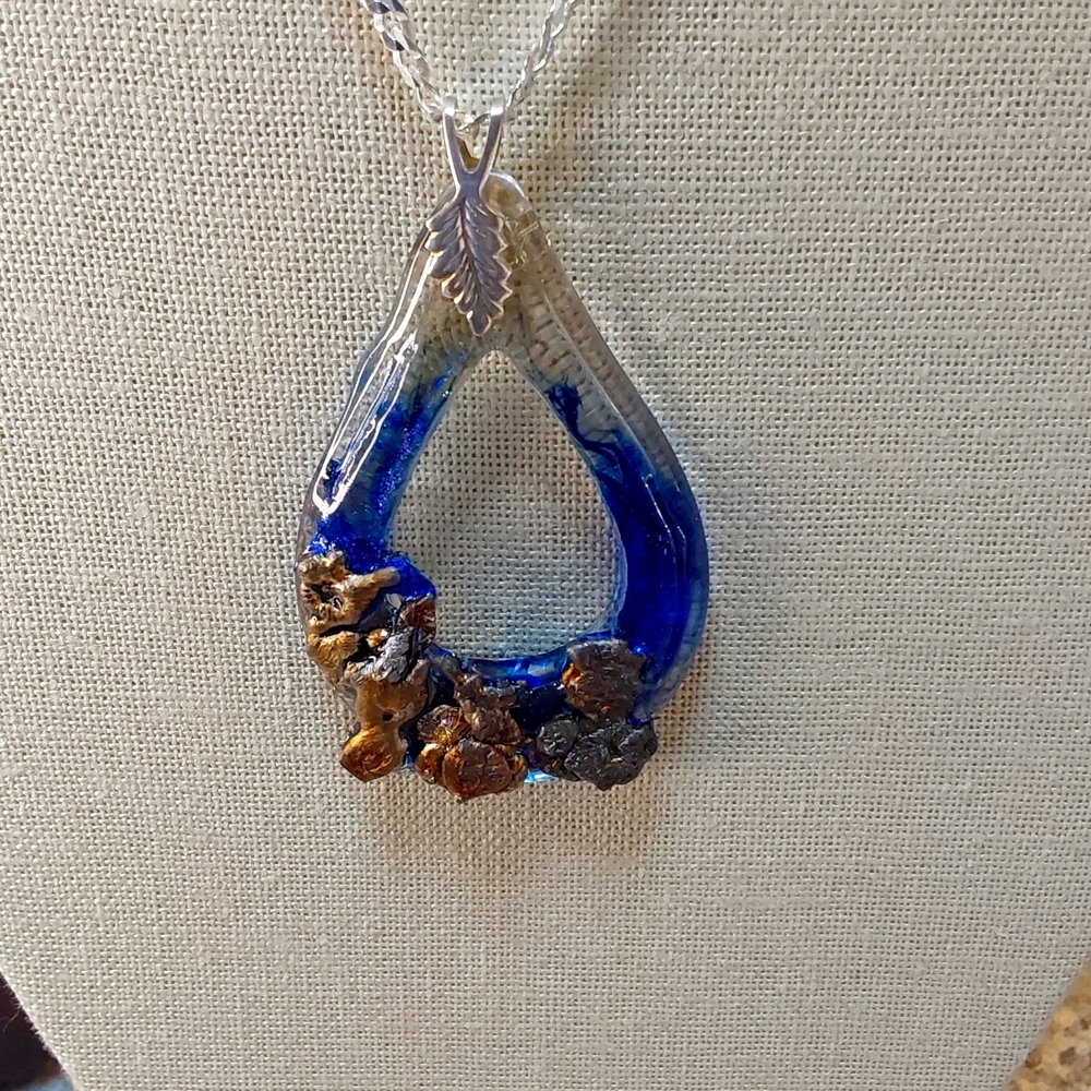 Necklace  mixed metal over resin. Silver bail